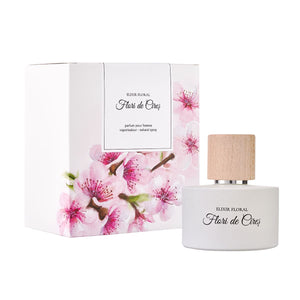 Parfum „Elixir Floral Flori de Cireș” cu capac din lemn, cutie decorată cu flori roz de cireș.
