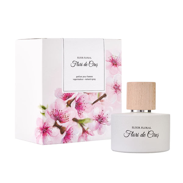 Parfum „Elixir Floral Flori de Cireș” cu capac din lemn, cutie decorată cu flori roz de cireș.